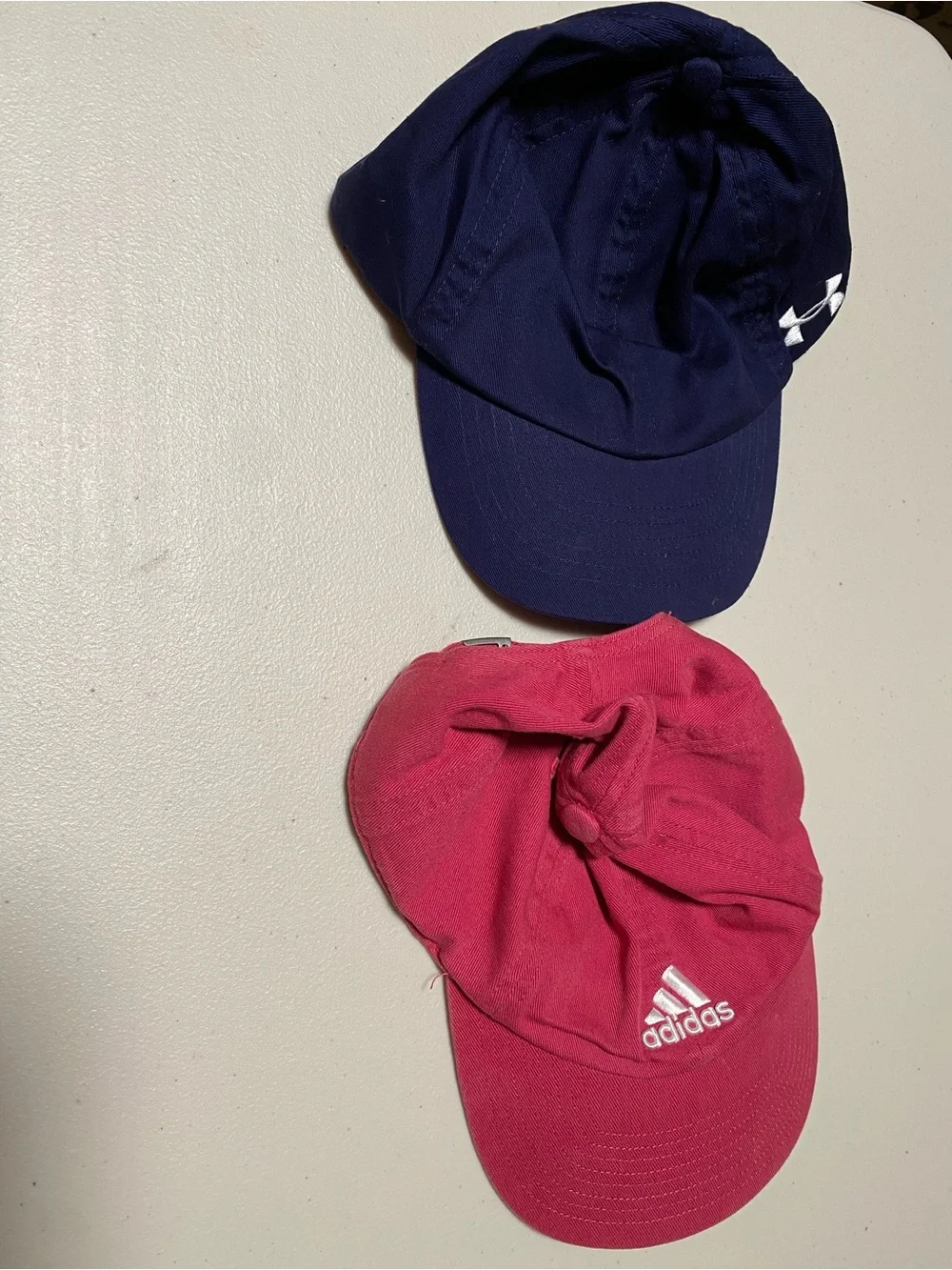 NWOT 2 for 19 NWOT Adidas pink & Under Armour navy logo baseball caps - set of 2
